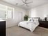 3 BR Apartments in Glendale AZ - Acero at the Stadium - Carpeted Bedroom with a Large Bed, White WAlls, Wooden Dresser and Nightstand Cabinet, Ceiling Fan, and a Window
