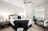 Bedroom with ceiling fan and natural light
