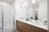 Apartments for Rent in Goodyear, AZ - Acero Roosevelt - Bathroom with a Double Sink Vanity, a Stand-In Shower, and Built-In Shelves