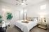 3-Bedroom Apartments in Goodyear, AZ - Acero Roosevelt - Bedroom with Plush Carpeting, Multiple Windows, and a Ceiling Fan