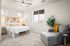 Three Bedroom Luxury Apartments in Eastmark AZ - Acero Hawes Crossing - Carpeted Bedroom with White Walls, a Ceiling Fan, a Bed, an Armchair, and Three Windows
