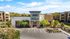 Apartments for Rent in Goodyear AZ - Acero Roosevelt - A 3D Rendering Of The Exterior Parking Lot With Beautiful Landscaping In Front Of The Leasing Office And The Apartment Buildings