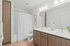 Vancouver WA Apartments Near Costco - Acero Jensen Park - Bathroom Featuring Large Mirror, Dual Sink, And Shower/Tub