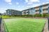 Vancouver, WA, pet Friendly Apartments - Acero Jensen Park - A Dog Park with a Fenced, Surrounding Residential Buildings, Landscaping, and Open Sky.