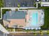 3 BR Apartments in Vancouver WA - Acero Jensen Park - Aerial View of Building Top and Pool Area, with Umbrellas, Spa, Lounge Poolside Chairs, and Fresh Lawns