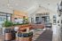 One-Bedroom Apartments in Camas, WA - Bennington on First - Modern Resident Lounge With Sectional Sofa, Pool Table, Bar Style Kitchenette, Tall Ceilings, And Large Windows For Natural Light.