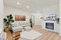 Vancouver, WA apartments for Rent - Bennington on First - Living Room - Couch - Fireplace - Wood-Style Flooring - Rug - Plant