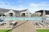 One BR Apartments in Vancouver, WA - Bennington on First - Pool with Lounge Chairs and Landscaping.
