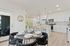 Two-Bedroom Apartments in Camas, WA - Bennington on First - Open Concept Dining Area And Kitchen Featuring A Round Dining Table With Upholstered Chairs, Wood Flooring, And Adjacent To The Kitchen.