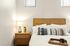 2 BR Apartments in West Phoenix, AZ - Meritum Sheely Farms - Bedroom Featuring Vinyl Plank Flooring And Stylish Decor