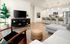West Phoenix AZ Apartments - Meritum Sheely Farms - Living Room Featuring Vinyl Plank Flooring, Modern Light Fixtures, And Stylish Decor