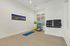 Bright home gym corner with yoga mats, exercise balls, and motivational decor, perfect for personal fitness sessions.