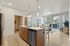 Bright and modern open-concept kitchen and living area with stylish island, contemporary furniture, and large windows for natural light.