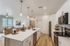 Modern open-concept kitchen and living area with sleek countertops, stylish lighting, and inviting dining space.