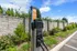 Convenient EV charging station in a picturesque setting, surrounded by lush greenery and a stone wall, offering eco-friendly amenities.