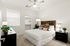 1-Bedroom Apartments in East Mesa, AZ - Acero Eastmark - Spacious Bedroom With Wood Headboard, Ceiling Fan, Window Blinds, Carpet Flooring, and Open Closet.