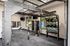 Modern gym with state-of-the-art equipment, featuring TRX straps, kettlebells, and medicine balls in a bright, spacious room.