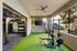 Modern outdoor gym area featuring state-of-the-art fitness equipment and lush greenery, perfect for an invigorating workout experience.