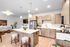 Pet-friendly apartments in Vancouver, WA Modern open-concept kitchen and living area with sleek wooden cabinets, stainless steel appliances, and stylish pendant lighting.