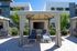Inviting outdoor cabana featuring two modern lounge chairs, a flat-screen TV, and vibrant greenery, perfect for relaxation.