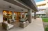 Chic outdoor patio with stylish wicker furniture and inviting glass doors leading to a modern interior.