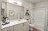 Elegant bathroom with modern fixtures, sleek white countertop, and stylish shelving complete with decorative plants.