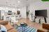Contemporary open-concept living area with a chic kitchen, stylish bar seating, modern appliances, and cozy lounge space.