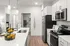 Modern kitchen with sleek appliances, elegant countertops, and stylish lighting, offering a warm and inviting atmosphere.