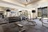 Modern gym with state-of-the-art exercise machines, free weights, and spacious workout area, ideal for fitness enthusiasts.