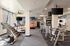Spacious and modern gym with state-of-the-art fitness equipment, including treadmills and strength machines, enhanced by natural lighting and stylish d&eacute;cor.