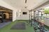 Modern fitness center featuring state-of-the-art equipment, weight racks, and open space for versatile workouts.