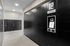 Modern package concierge area with sleek black locker units and secure automated system, enhancing convenience and safety for residents.