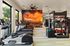 Bright and modern gym with state-of-the-art equipment and stunning desert sunset mural.