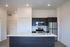 Modern kitchen with sleek dark cabinetry, stainless steel appliances, and a polished island countertop, perfect for entertaining and culinary adventures.