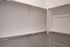 Spacious walk-in closet with sleek, modern design and ample hanging space.