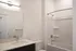 Elegant bathroom featuring sleek fixtures, a spacious vanity, and a modern bathtub with shower.
