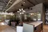 Modern office space with chic lighting, stylish seating, and large glass windows, offering a sleek and productive environment.