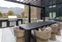 Modern outdoor patio with elegant dining set, surrounded by scenic mountain views, perfect for entertaining and relaxation.
