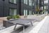 Modern apartment courtyard showcasing a sleek table tennis setup, elegant landscaping, and stylish architectural design.