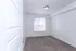 Bright and inviting bedroom with large window, plush carpet, and modern light fixture, perfect for a cozy retreat.