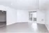 Bright and spacious living room with modern wood flooring, large windows, and a welcoming open layout.
