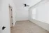 Bright and airy room with modern hardwood floors and a sleek ceiling fan, perfect for personalized decor.