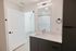 Sleek bathroom with modern fixtures, elegant vanity, and stylish subway tile shower, offering a serene escape.