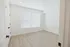 Bright and inviting room with large window, sleek modern flooring, and recessed lighting, perfect for a cozy and stylish living space.