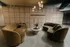 Chic lobby area featuring modern decor, elegant curved sofas, a stylish coffee table, and sophisticated lighting.