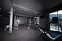Modern exercise room with state-of-the-art equipment, featuring treadmills and stationary bikes, showcasing a sleek and inviting fitness space with large windows for natural light.