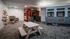 Charming children's playroom with train-themed decor featuring a cozy reading chair and a small picnic table, perfect for imaginative adventures.