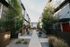 Charming apartment complex with modern architecture, lush landscaping, and inviting pathways.