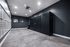 Modern mailroom with sleek black lockers and multiple mailboxes, ideal for convenient package management in a stylish apartment complex.