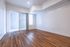 Bright and airy living space with elegant wood flooring and large sliding glass doors, perfect for modern living.
